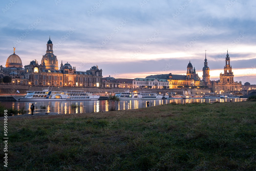 View from the Königsufer to the skyline from the oldtown from the city Dresden with the Frauenkirche at sunset.