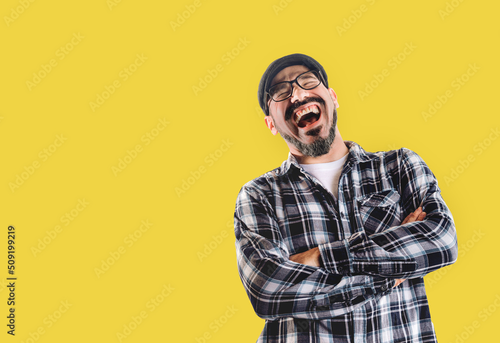Man laughing very hard isolated on yellow background. Good mood, jokes and happiness Man laughing very hard isolated on yellow background. Good mood, jokes and happiness