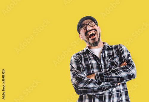 Obraz na plátně Man laughing very hard isolated on yellow background