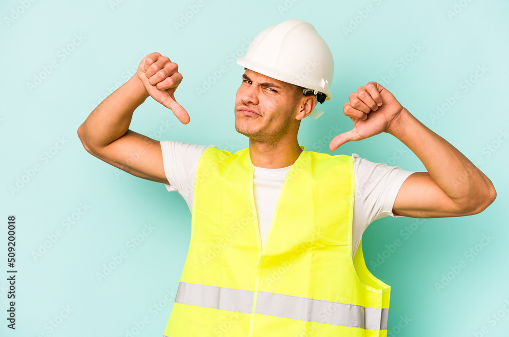 Young laborer caucasian man isolated on blue background feels proud and self confident, example to follow.