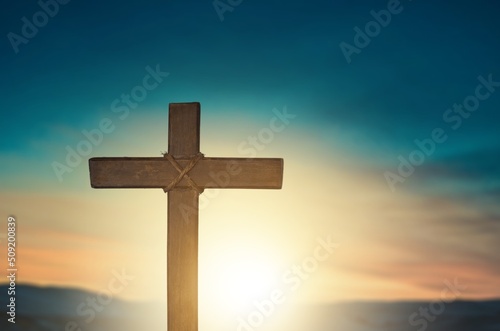Classic wooden cross on sky background