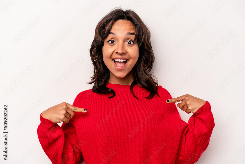 Young hispanic woman isolated on white background surprised pointing with finger, smiling broadly. Young hispanic woman isolated on white background surprised pointing with finger, smiling broadly.