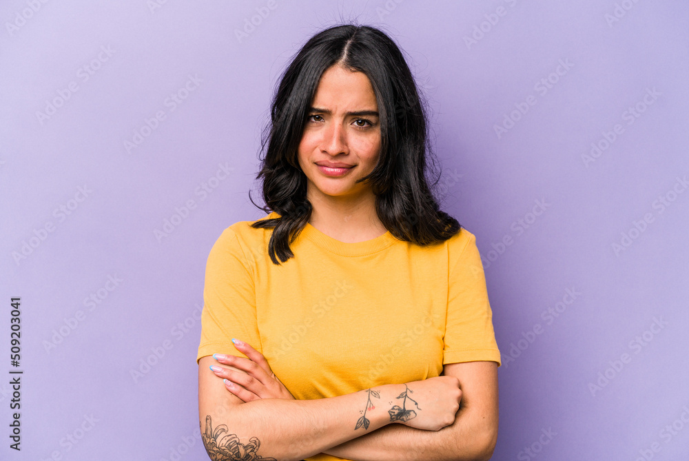 Young hispanic woman isolated on purple background unhappy looking in camera with sarcastic expression. Young hispanic woman isolated on purple background unhappy looking in camera with sarcastic expression.