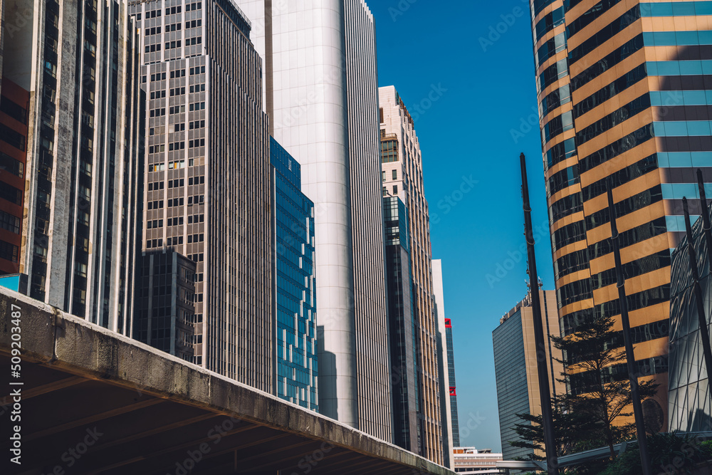Fototapeta premium Modern business district of megalopolis with tall skyscrapers and rental commercial apartments, high skyscraper rising in downtown with offices and corporate headquarters