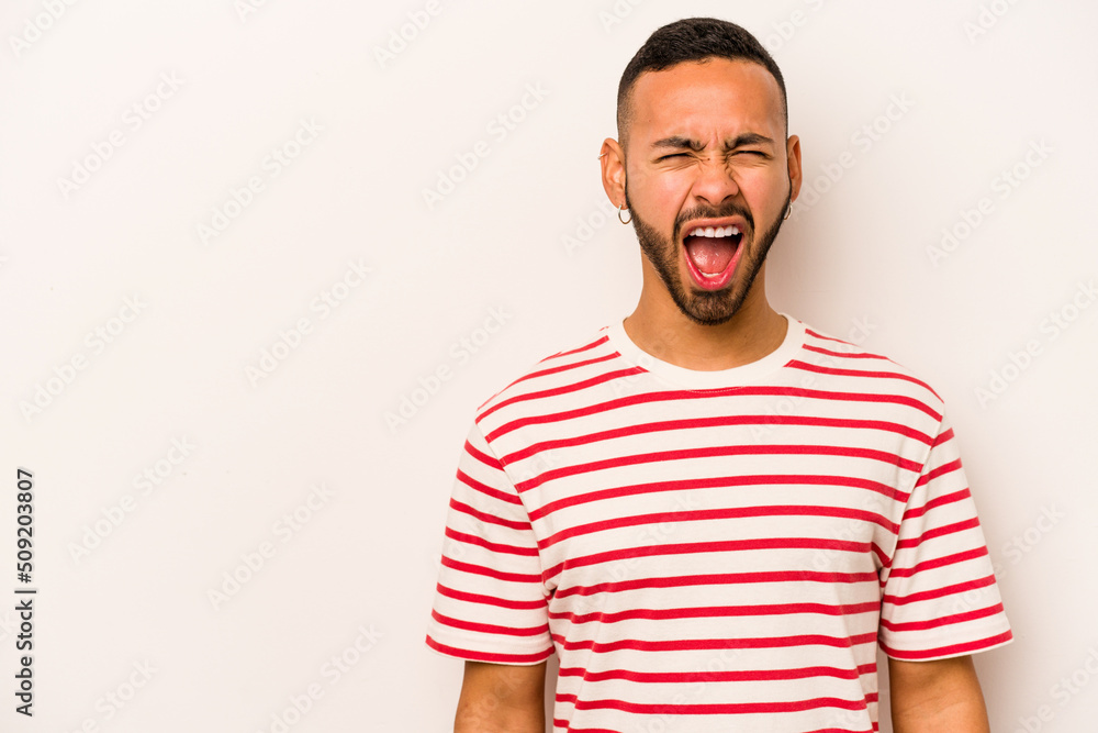 Young hispanic man isolated on white background shouting very angry, rage concept, frustrated. Young hispanic man isolated on white background shouting very angry, rage concept, frustrated.
