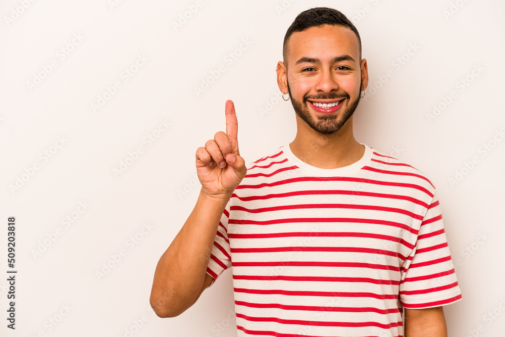 Young hispanic man isolated on white background showing number one with finger. Young hispanic man isolated on white background showing number one with finger.