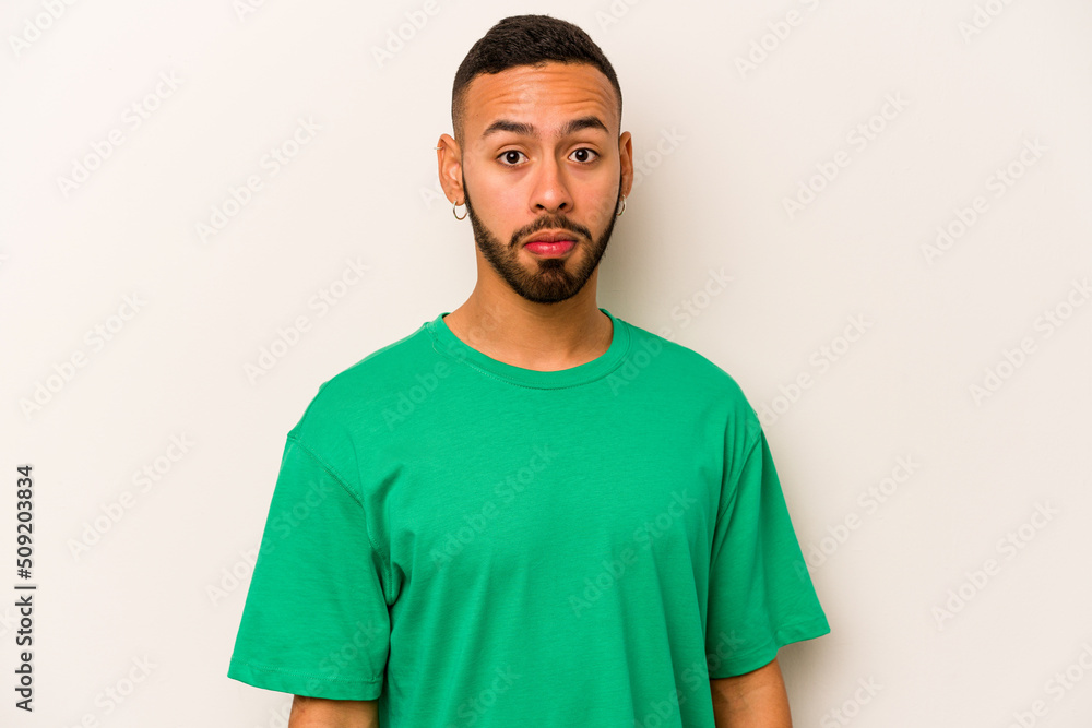 Young hispanic man isolated on white background sad, serious face, feeling miserable and displeased. Young hispanic man isolated on white background sad, serious face, feeling miserable and displeased.