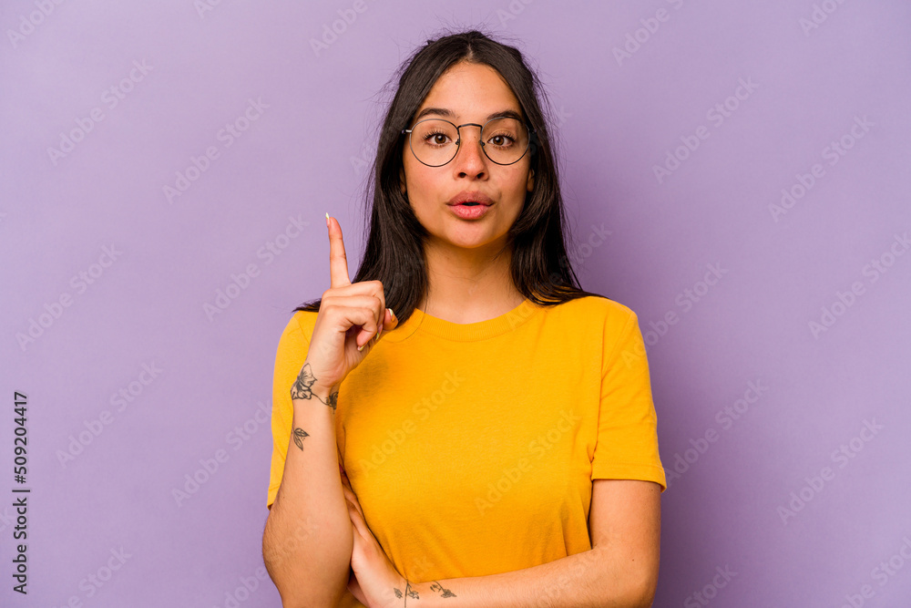 Young hispanic woman isolated on purple background having some great idea, concept of creativity. Young hispanic woman isolated on purple background having some great idea, concept of creativity.