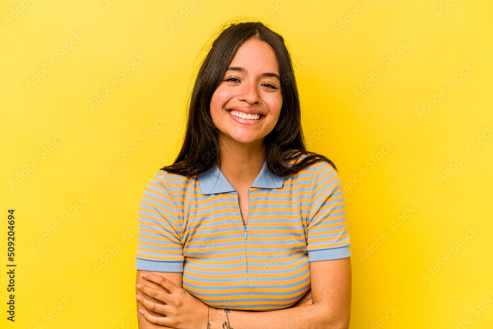Young hispanic woman isolated on yellow background laughing and having fun. Young hispanic woman isolated on yellow background laughing and having fun.