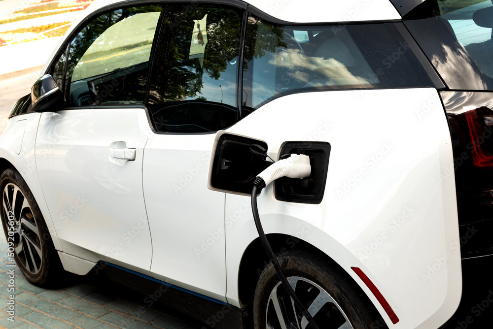 Electric car at the charging station. Ecology. Eco-friendly transport Electric car at the charging station. Ecology. Eco-friendly transport