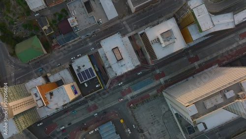 Fly above high rise office or apartment buildings and family houses in city. Top down footage at dusk. Port Elisabeth, South Africa