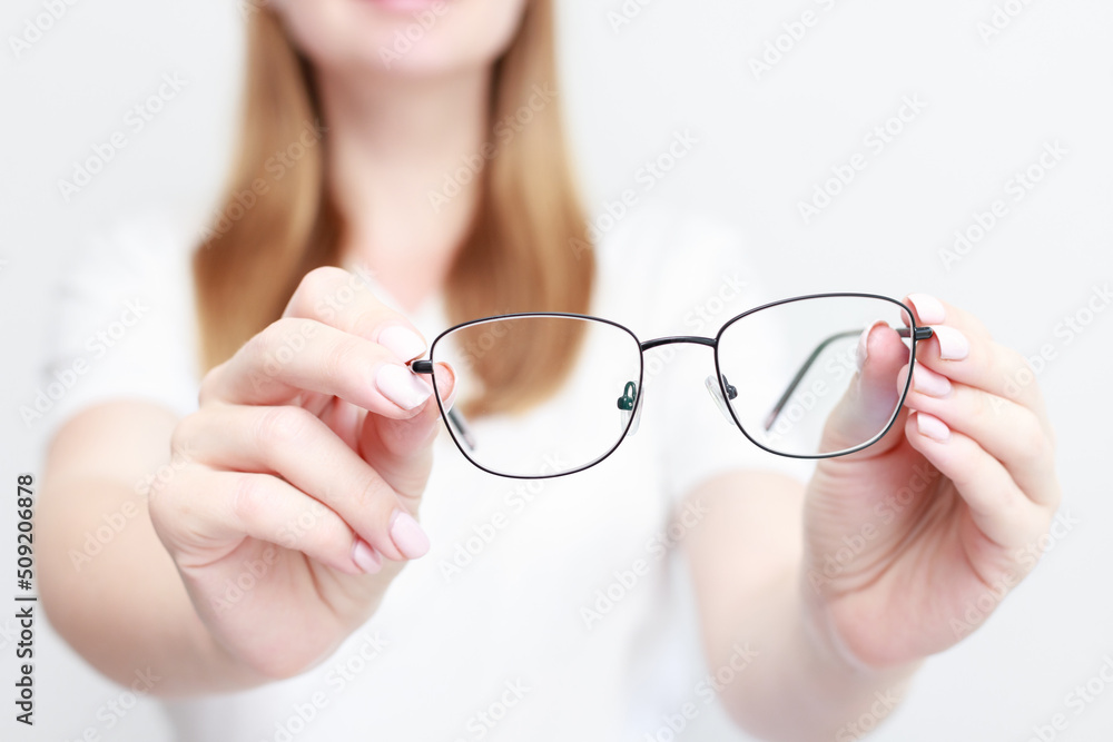 woman shows close-up glasses. vision correction woman shows close-up glasses. vision correction