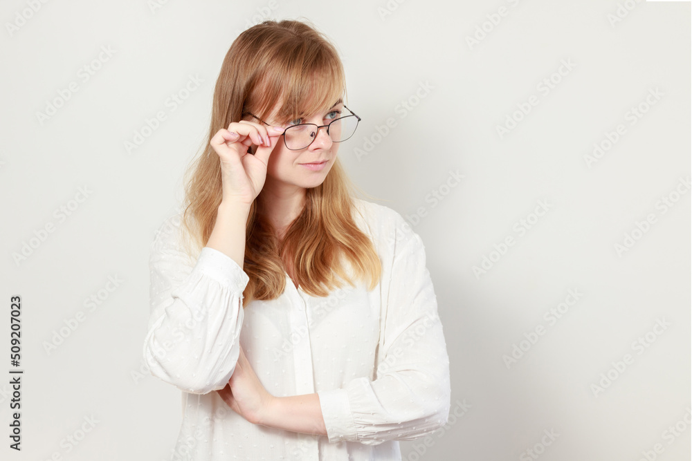 a woman in glasses and a blouse on a white background