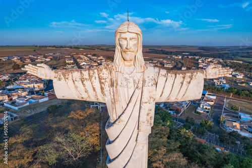 Sertaozinho, São Paulo / Brazil - Circa june 2022: Aerial image of the city of Sertaozinho, SP. Christ the Redeemer monument of the city, way of faith. photo