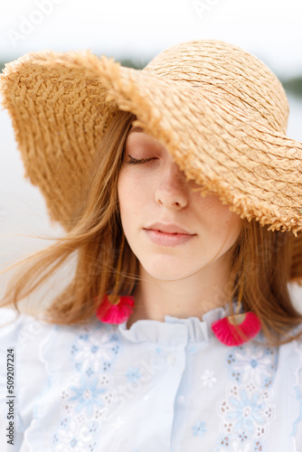 a woman in a straw fashion hat. summer mood