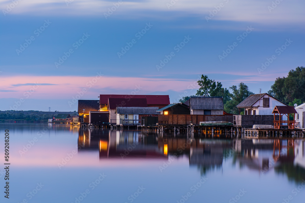 Floating village on Bokod lake in Hungary, dramatic sunset sky