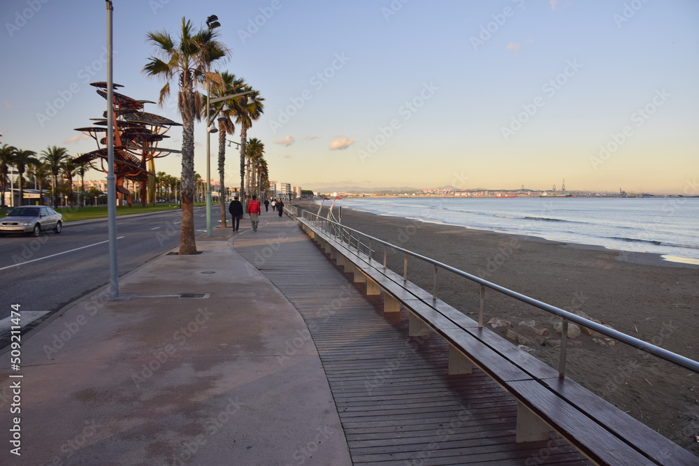 La Pineda, Spain - November 13, 2019:Wooden sidewalk along the beach
