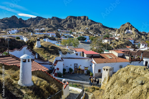 Guadix, Spain - 09 november 2019: View from the hill to Guadix, is famous for its cave houses. These cave houses are up in the hills and are in the Troglodyte Quarter (Barrio Troglodyte) of the city photo