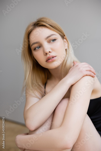 Portrait of stylish young woman looking away at home.