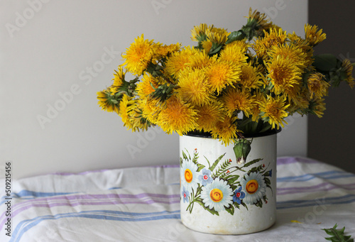 Yellow dandelions in a rustic vase
