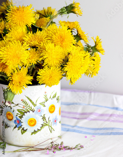 Yellow dandelions in a rustic vase