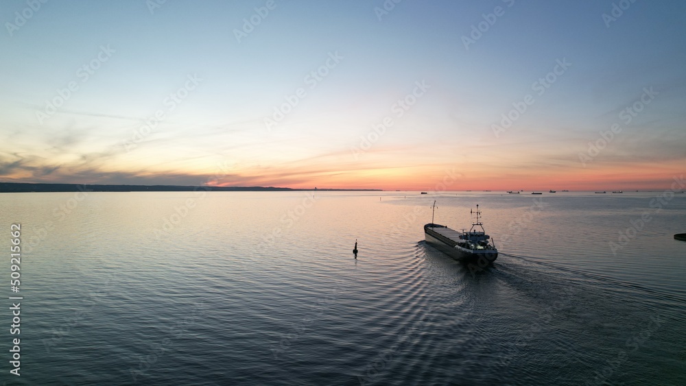 Cargo ship on the background of the fiery sunset of the Baltic Sea. Cargo ship on the background of the fiery sunset of the Baltic Sea.
