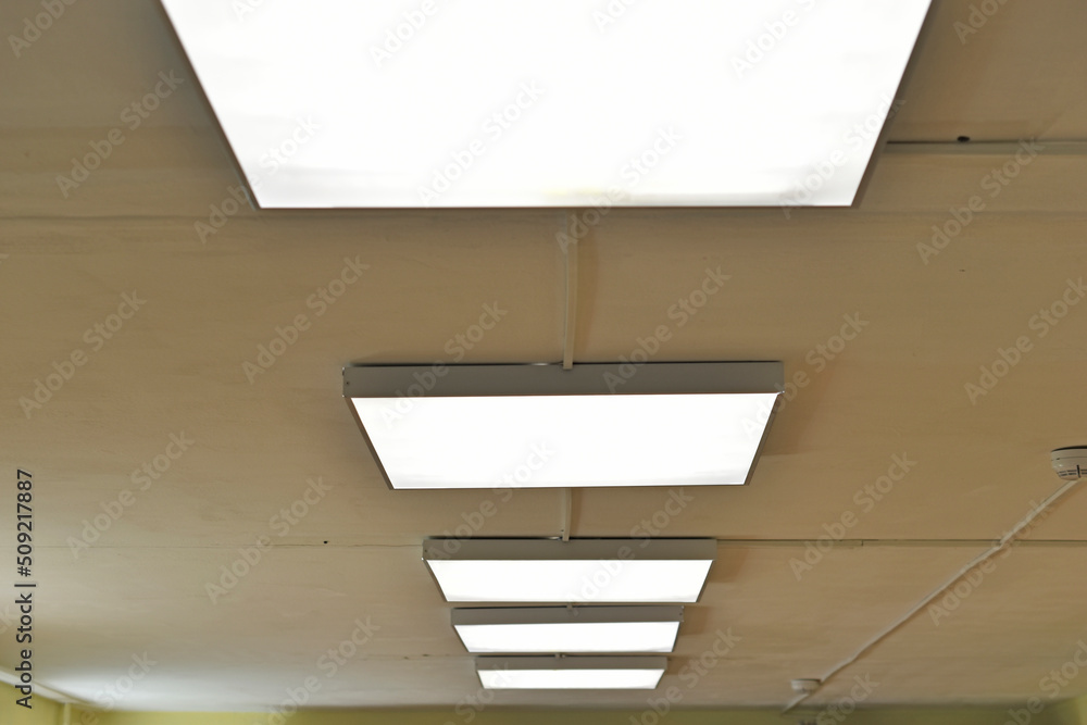 Fototapeta premium Square white lamp on the ceiling in the office