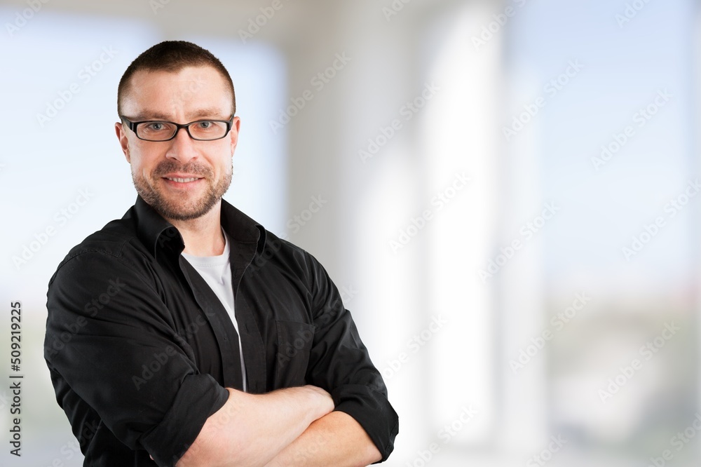 Happy mature male business leader standing at office window. Job success concept Happy mature male business leader standing at office window. Job success concept