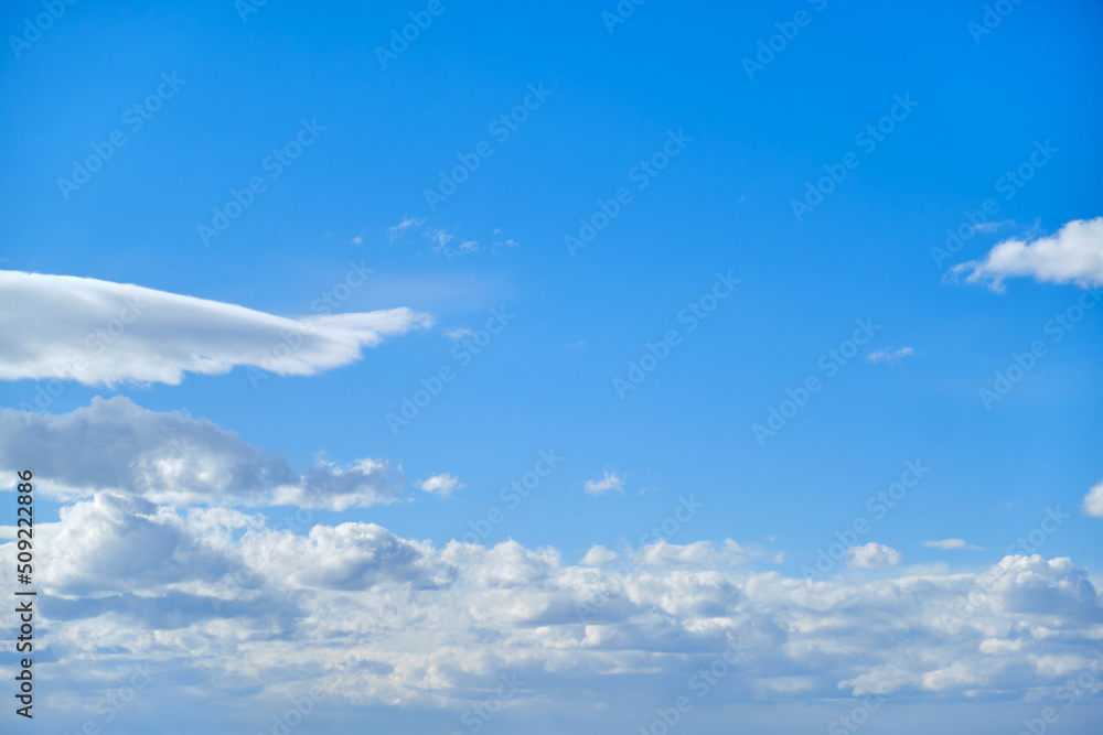 Blue sky with white cumulus clouds. Bright sunny day with cloudy sky Blue sky with white cumulus clouds. Bright sunny day with cloudy sky
