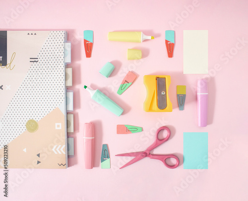 Creative flat lay concept of pastel office and school supplies. Cute little notebooks, felt-tip pens, scissors and bookmarks.