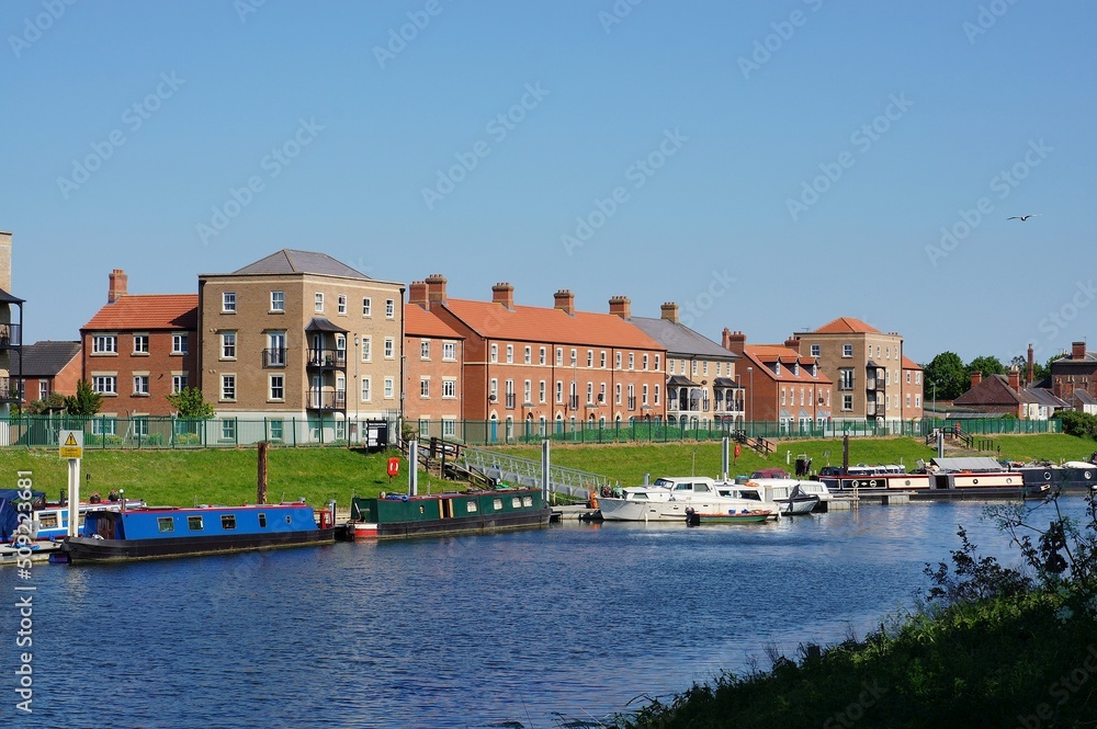 New build housing and boats on the river Witham