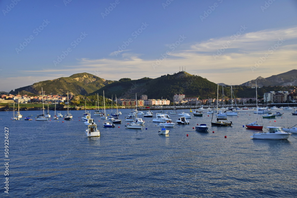 Colorful fishing boats anchored near the port. The Way of St. James, Northern Route, Spain