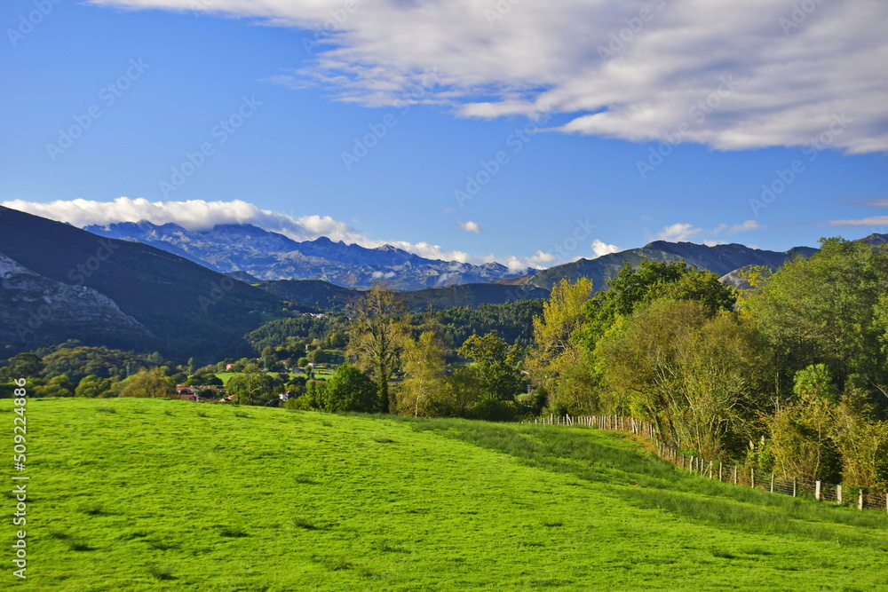 View of the rural landscape against the background of mountains and blue sky . The Way of St. James, Northern Route