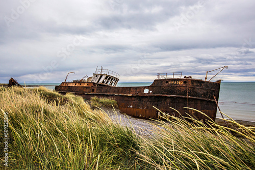 Shipwreck called Amadeo on the  coast of Magellan Strait, rusty warship wreck, Tierra Del Fuego, Chile photo