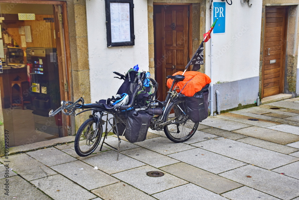 Santiago de Compostela, Spain. A loaded pilgrim's bicycle near the building.