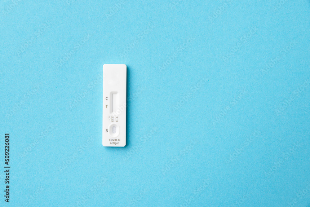 Test cartridge for covid-19 virus incidence analysis, blue background, copy space. Test cartridge for covid-19 virus incidence analysis, blue background, copy space.