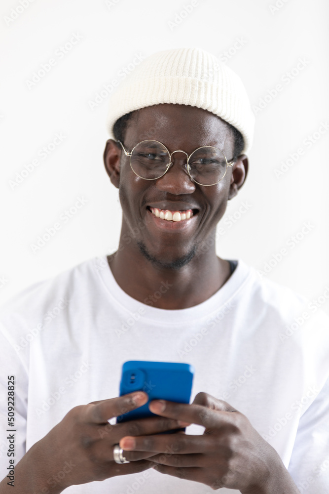 African american man in eyeglasses and white hat using smartphone. African american man in eyeglasses and white hat using smartphone.