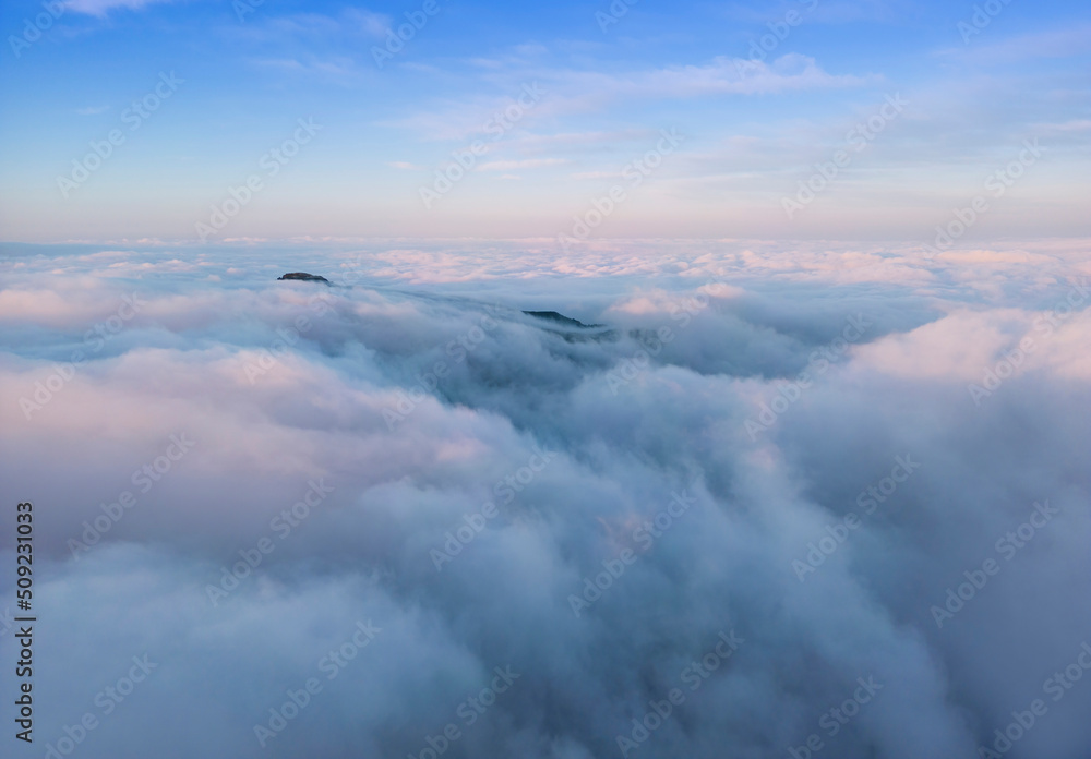 aerial vire of mountain top above the clouds. Ceahlau, Romania