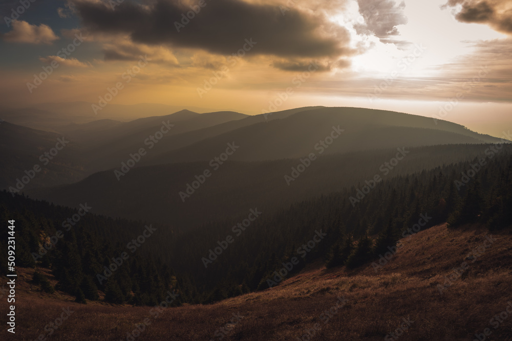 Landscape of warm light sun rays on sky through the clouds over the mountains in Czech republic, Jeseniky