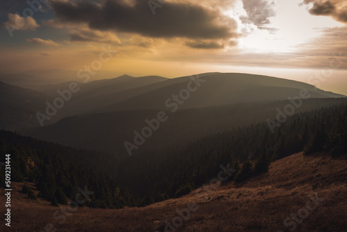 Landscape of warm light sun rays on sky through the clouds over the mountains in Czech republic  Jeseniky