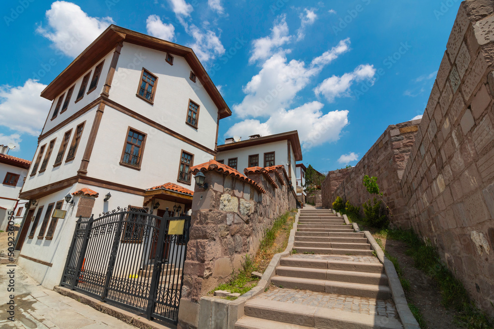 Ankara Castle and traditional Turkish houses with partly cloudy sky.