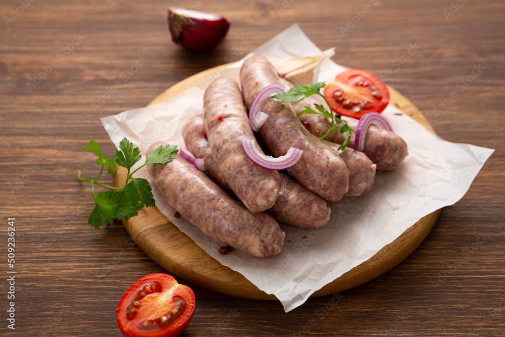 Raw barbeque wurst sausage on wooden surface Raw barbeque wurst sausage on wooden surface