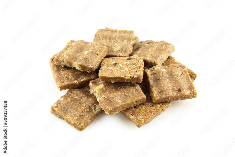 Bunch of bite size oatmeal cookies isolated on white background. Light dietary food