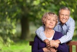 Portrait of happy elderly couple together, take care and love with good relationship, in the park