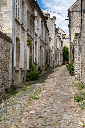 Senlis, medieval city in France, typical street with ancient houses
