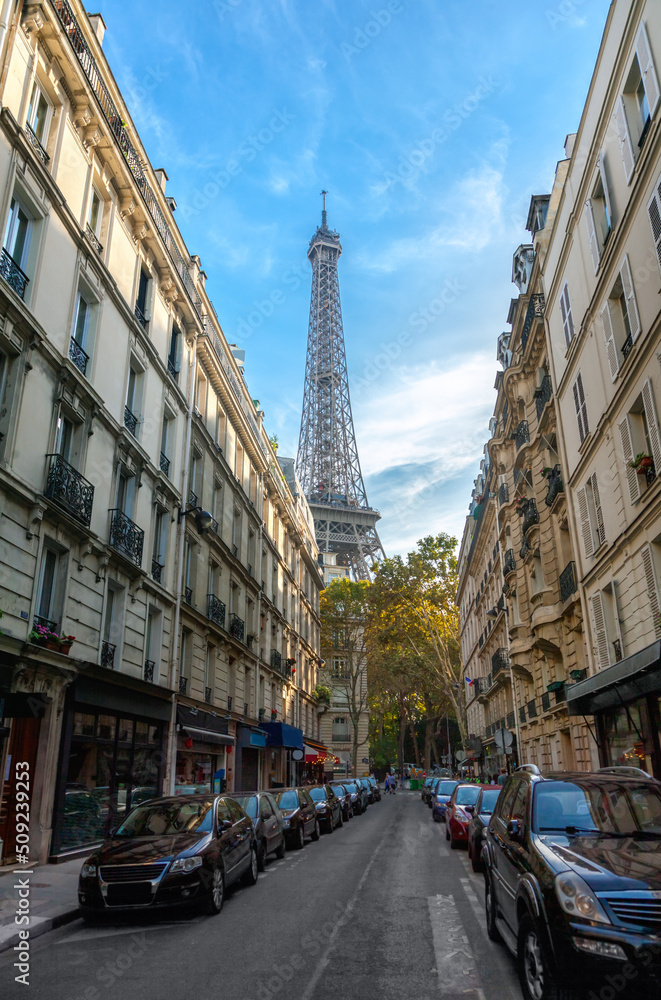 Eiffel tower between buildings in Paris
