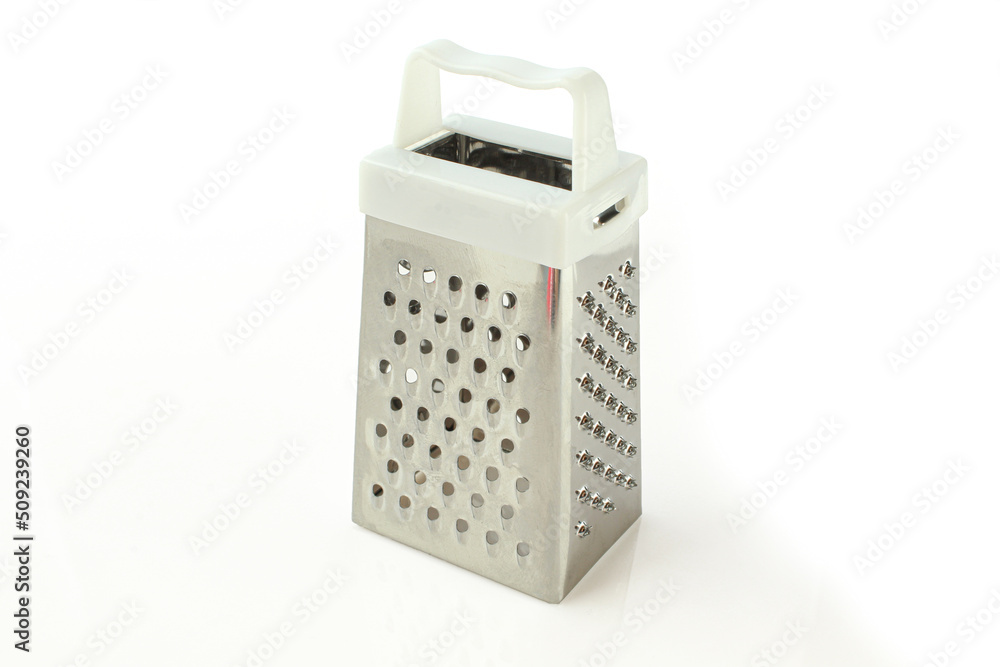 Small mettallic grater with white plastic handle isolated. Slicing kitchen equipment Small mettallic grater with white plastic handle isolated. Slicing kitchen equipment
