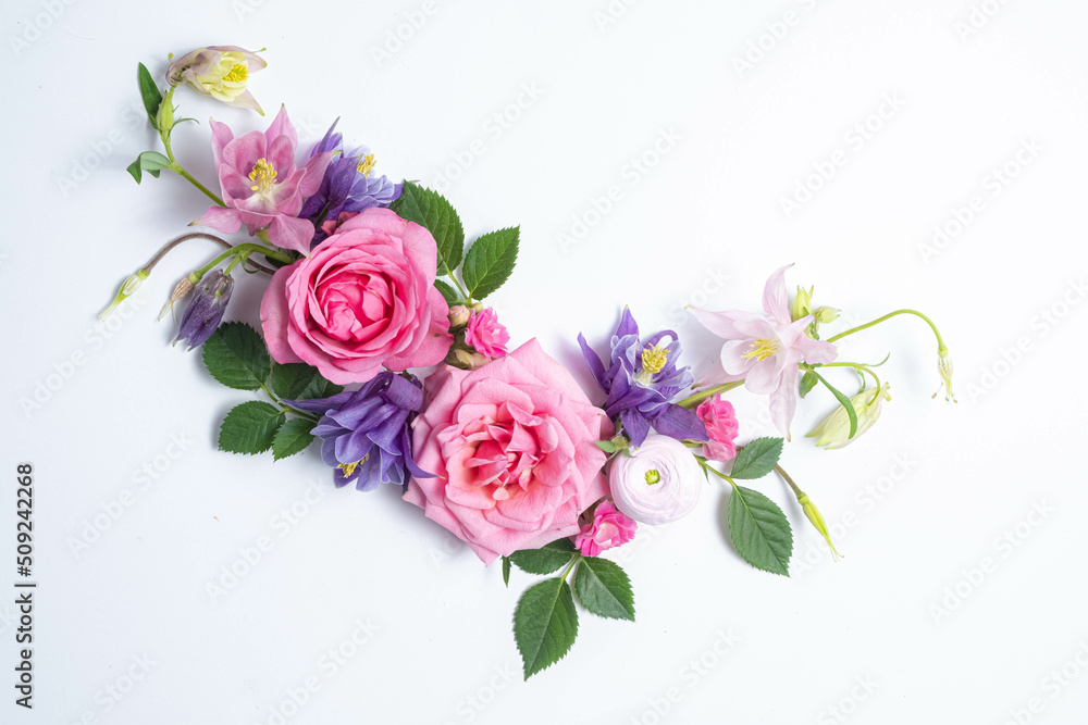 Festive floral background. floral layout from pink and violet flowers of aquilegia on a white background. Top view, flat lay.