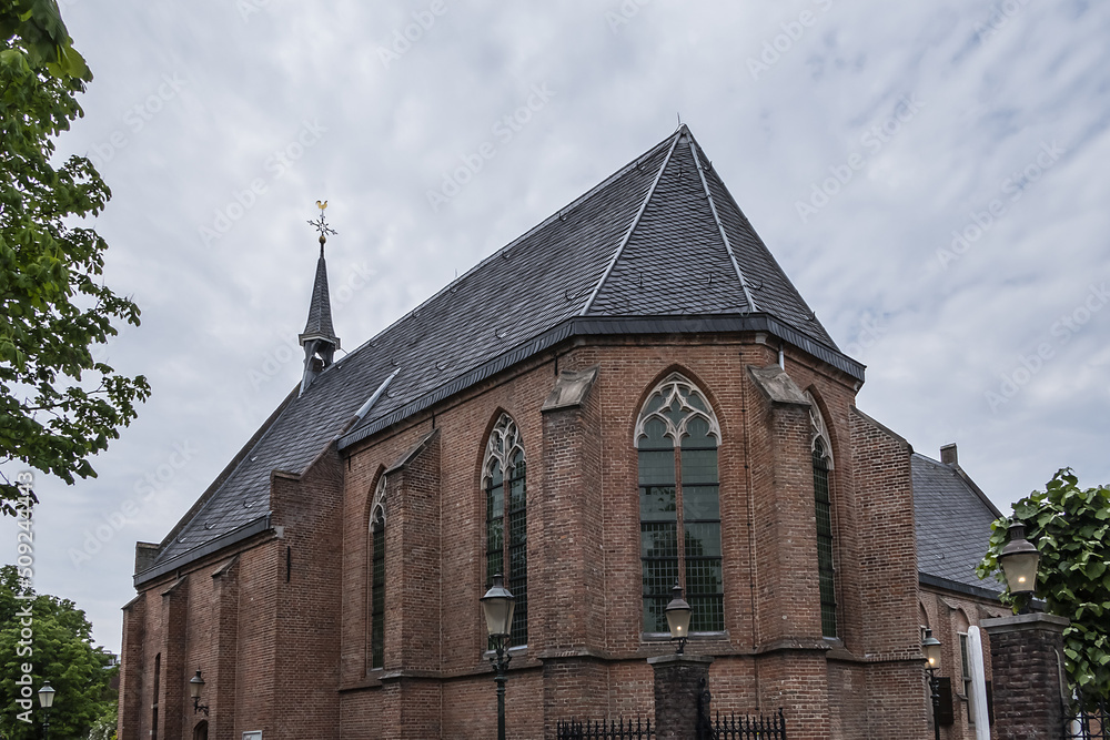 Intimate Chapel from 1390 with its beautiful arched windows and men's hall (Mannenzaal) behind it - remained from medieval building of St. Pieters en Bloklands Gasthuis. Amersfoort, the Netherlands. Intimate Chapel from 1390 with its beautiful arched windows and men's hall (Mannenzaal) behind it - remained from medieval building of St. Pieters en Bloklands Gasthuis. Amersfoort, the Netherlands.