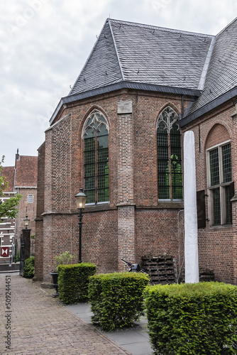 Intimate Chapel from 1390 with its beautiful arched windows and men's hall (Mannenzaal) behind it - remained from medieval building of St. Pieters en Bloklands Gasthuis. Amersfoort, the Netherlands. photo